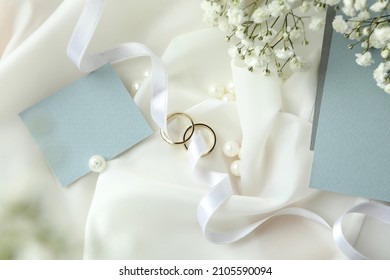 Concept of wedding accessories with wedding rings, close up