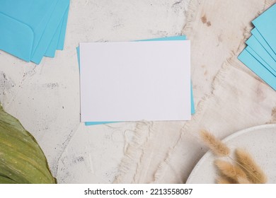 The Concept Of Wedding Invitation Cards, Dinner Invitations, Offices And Others. Blank Paper And Envelope, With White Cement Background.