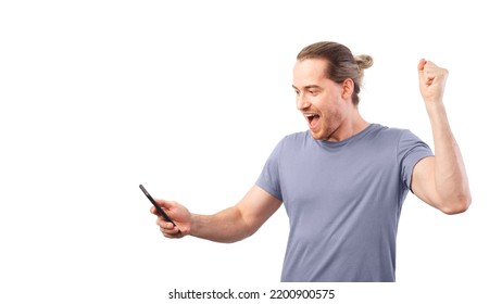 Concept of winning a lottery or a sweepstake. Excited man rejoices looking at his smartphone. - Shutterstock ID 2200900575