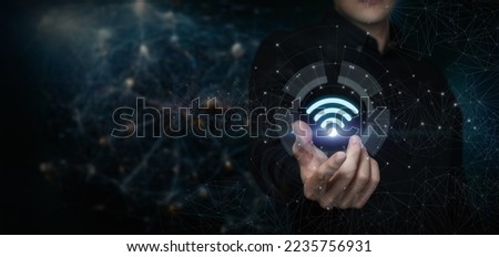 The concept of a wireless network. A man shows a wi-fi icon.