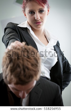 concept of a woman humiliating a man on the workplace