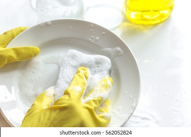concept of woman washing dishes on white background