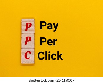 The concept of the word known as PPC or Pay Per Click has a yellow background. - Shutterstock ID 2141150057
