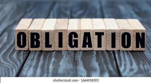 concept word obligation on cubes on a beautiful gray blue background - Shutterstock ID 1664918392