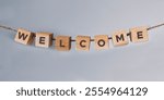 Concept word WELCOME on hanging wooden block. Welcome symbol with copy space