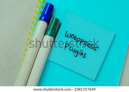 Concept of Wordpress Plugin write on sticky notes isolated on Wooden Table.