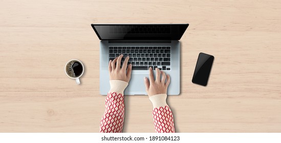 Concept Work From Home, Person Using A Laptop Computer With Blank Screen On Table And Have Coffee, Mobile Phone. Top View.