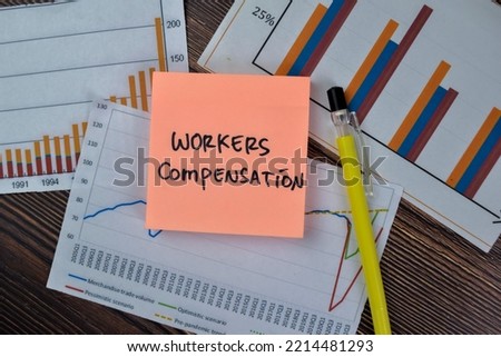 Concept of Workers Compensation write on sticky notes isolated on Wooden Table.