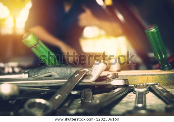 Concept of working in a car service center :\
Closeup, Wrench The mechanic screwdriver is placed near the\
technician to facilitate the engine\
checker.\
\
