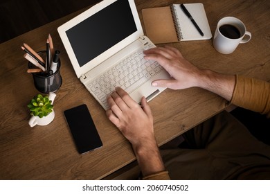 The Concept Of Working Outside The Office. An Overhead View Of A Male Freelancer Working On A Laptop At Home.