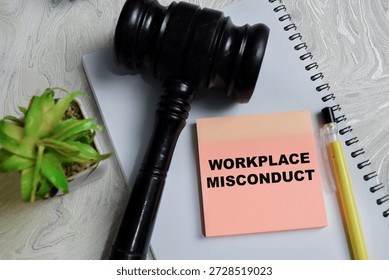 Concept of workplace misconduct write on sticky notes isolated on Wooden Table. Representing legal action, employee dispute and corporate accountability