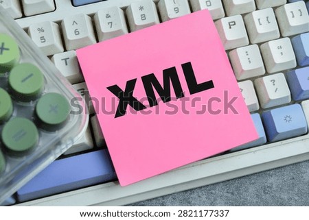 Concept of XML - Extensible Markup Language write on sticky notes isolated on Wooden Table.