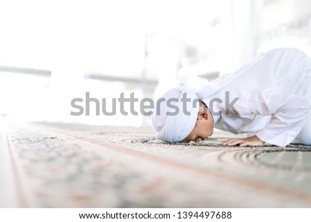 Concept of Young Asian Malay Muslim performing prostration or 