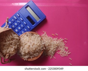 Concept of zakat. Selected focus rice in sack, bowl and calculator. Zakat is obligatory for Muslims and is considered an act of worship to cleanse the property acquired in a certain period and count. - Shutterstock ID 2253009349