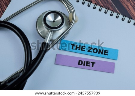 Concept of The Zone Diet write on sticky notes with stethoscope isolated on Wooden Table.