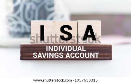 Concept-image for Individual Savings Account called an ISA. Stained and gold wooden blocks with embossed initials of ISA shot against a rustic background with generous accommodation for copy space.