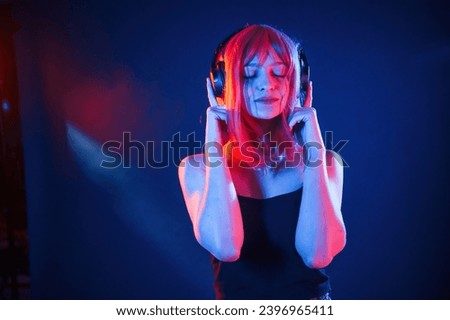 Similar – Young DJ woman in a night party