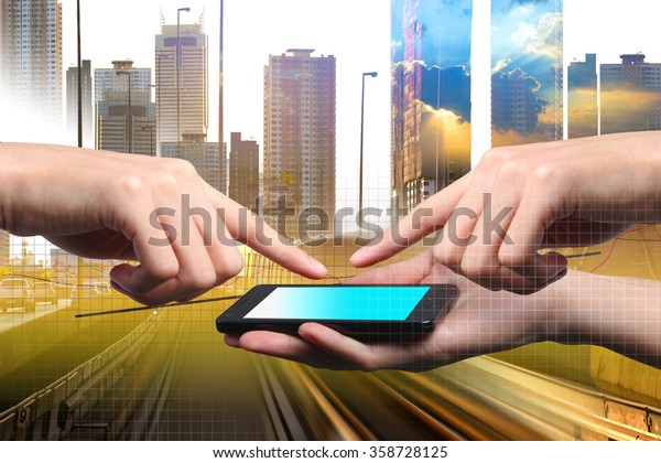 Conception of\
smartphone  connection in the city for business. Closed up hand of\
two persons are using touch\
screen.