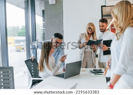 Conception of unity and teamwork. Group of professional business people is in the office.