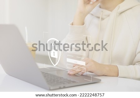 Concepts of cybersecurity and privacy to protect data. Businesswomen protecting personal data on laptop computer by virtual screen. Lock icon and login page that requires a username and password.