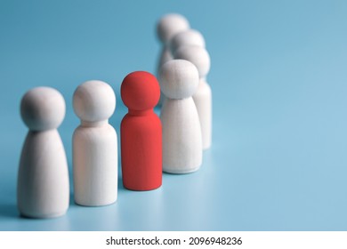 concepts of different thinking. assertiveness and self-confidence for success in life. red wooden dolls on blue background. with business style copy space - Shutterstock ID 2096948236