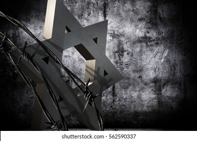 Conceptual background in memoriam of The International Holocaust Remembrance Day, representing a granite star of David barbed wire.