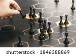 Conceptual board game with a hand moving pawns. Black and golden background. Concept of market positioning or business strategy. Composite image between a hand photography and a 3D background.