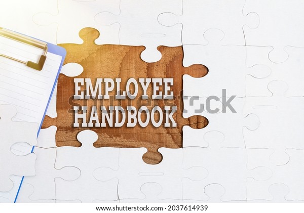 Conceptual\
caption Employee Handbook. Word for states the rules and\
regulations and policies of a company Building An Unfinished White\
Jigsaw Pattern Puzzle With Missing Last\
Piece