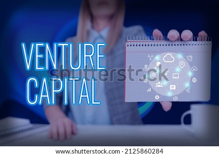 Conceptual caption Venture Capital. Business concept capital invested in a project in which there is risk Lady Pressing Screen Of Mobile Phone Showing The Futuristic Technology