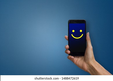 Conceptual The Customer Responded To The Digital Survey. The Client Showing Mobile Phone Screen With Happy Face. Depicts That Customer Is Very Satisfied. Service Experience And Satisfaction Concept.