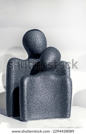 conceptual desktop black figurines of a woman and a man