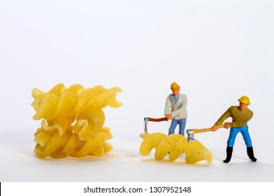 Conceptual Diorama Image Of Miniature Figures Shaping Fusilli Pasta