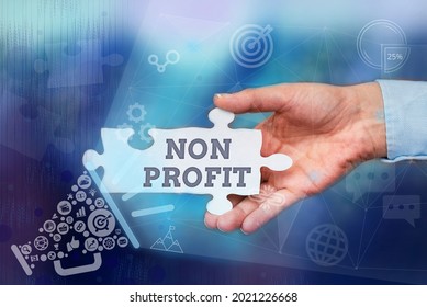 Conceptual Display Non Profit. Business Concept An Activity Not Making Or Conducted Primarily For A Profit Hand Holding Jigsaw Puzzle Piece Unlocking New Futuristic Technologies.