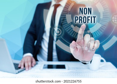 Conceptual Display Non Profit. Business Approach An Activity Not Making Or Conducted Primarily For A Profit Bussiness Man Sitting Desk Laptop And Phone Pointing Futuristic Technology.