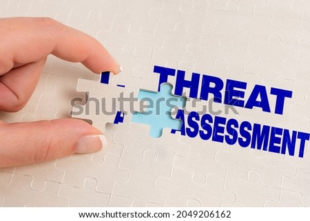 Conceptual display Threat Assessment. Concept meaning determining the seriousness of a potential threat Building An Unfinished White Jigsaw Pattern Puzzle With Missing Last Piece