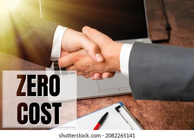 Conceptual Display Zero Cost. Business Concept Business Decision That Does Not Entail Any Expense To Execute Two Professional Well-Dressed Corporate Businessmen Handshake Indoors