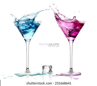 Conceptual Elegant Martini Glasses with Splashing Colored Cocktails with Ice Cube on the Table. Isolated on White Background with Copy Space at the Center. Template design with Sample Text - Powered by Shutterstock