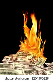Conceptual finance image of burning pile of money, dollar bills, and fire flames in black background