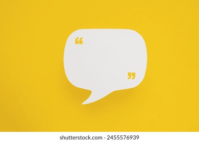 Conceptual image about communication and social media, customer feedback, real blank white speech bubble paper cut with quote sign on yellow color background