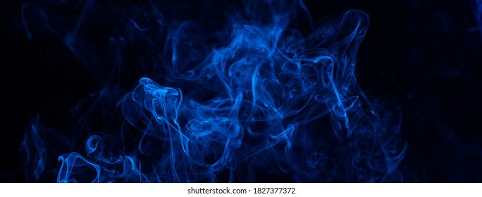 Conceptual image of blue color smoke isolated on dark black background, Halloween concept design element. - Powered by Shutterstock