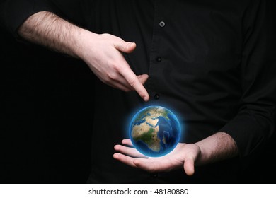 Conceptual image of a businessman with the world at his fingertips. - Shutterstock ID 48180880