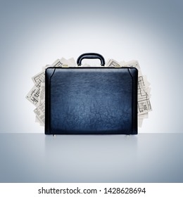 Conceptual image of classic black leather briefcase overflowing with plans, reports, and paperwork. Intellectual property and data theft and security
