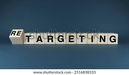 A conceptual image comparing the words TARGETING and RETARGETING on wooden blocks. This visual represents the two key strategies in digital marketing for reaching new and existing customers