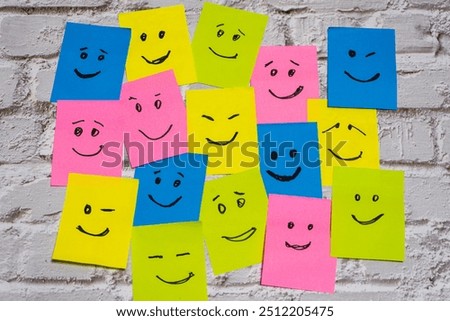 Conceptual image of different post-its of various colors with different smiley faces representing diversity and inclusion.