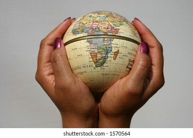 Conceptual Image Of Female Holding A Globe, Africa To The Forefront, Could Be Used To Illustrate Many Global/power Issues