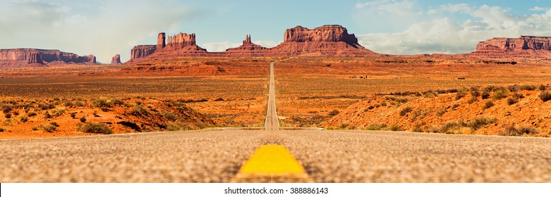 Conceptual Image - Hit The Open Road In Beautiful Southwest USA. Low Angle Street View Of Path Leading To Monument Valley National Park