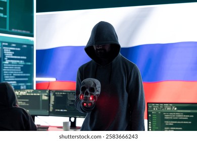 Conceptual image of a hooded russian hacker creating hazardous alerts, holds a skull and warning of death threats. Russian federation works on cybercrime and violence, panic and torment.