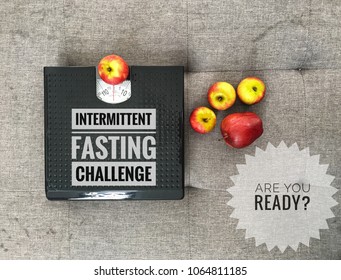 Conceptual Image Of Intermittent Fasting Challenge With Apples And Weight Scale As Symbolic Of Weight Loss