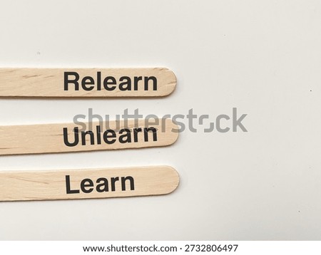 Conceptual image of Learn, Unlearn, and Relearn wooden blocks for personal development and education.