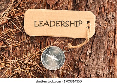 Conceptual Image: Magnetic compass with paper tag written LEADERSHIP, selective focus. - Shutterstock ID 1903814350